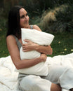 Kakun Organic Travel Pillow - held in woman's arms