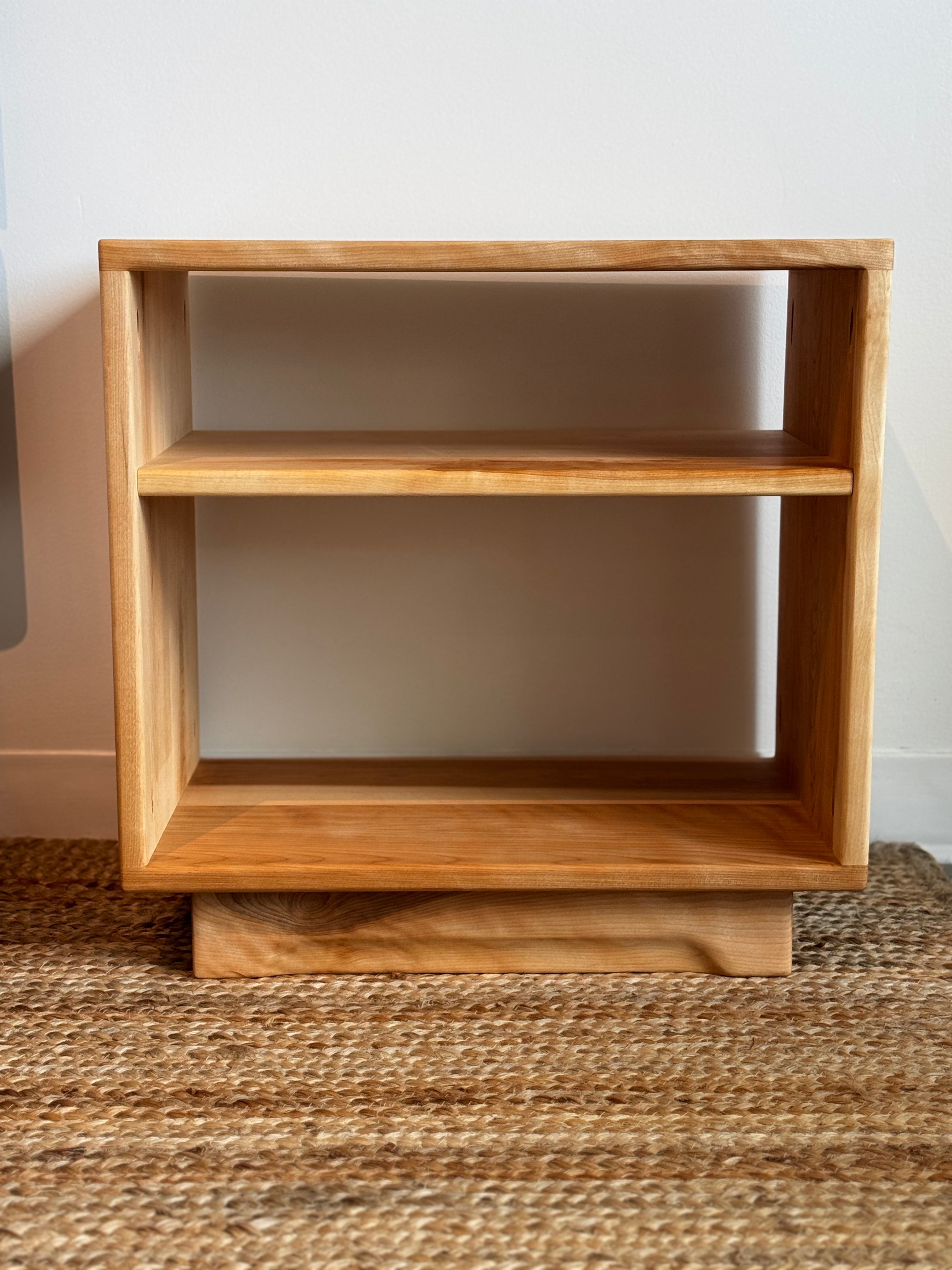Birchwood Bedside Table with a single open shelf on textured carpet