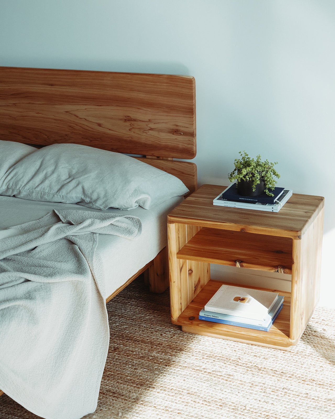 Adrift Cedar Crest Bedside Table - next to matching bed with natural lighting