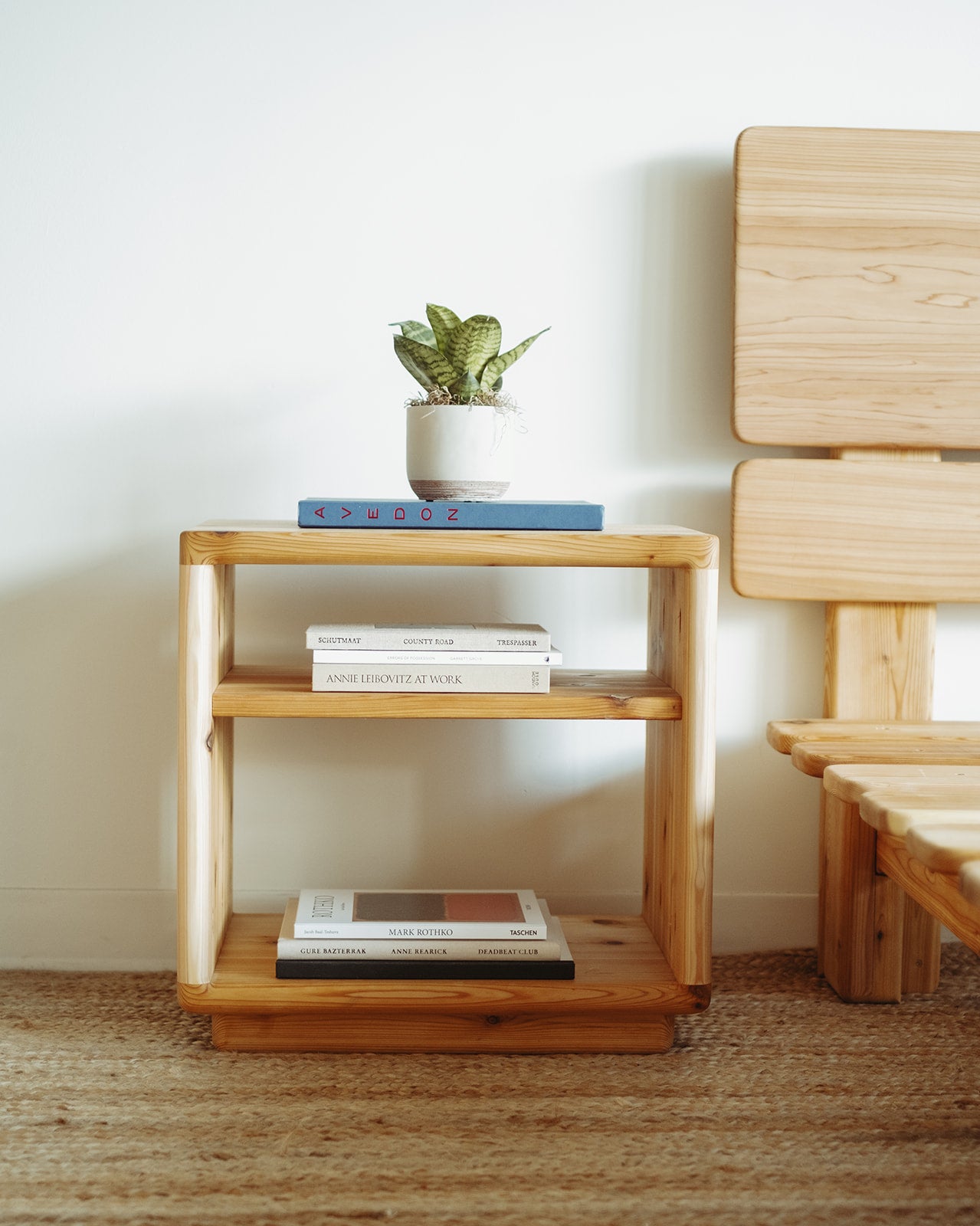 Adrift Cedar Crest Bedside Table - natural light with books on shelves