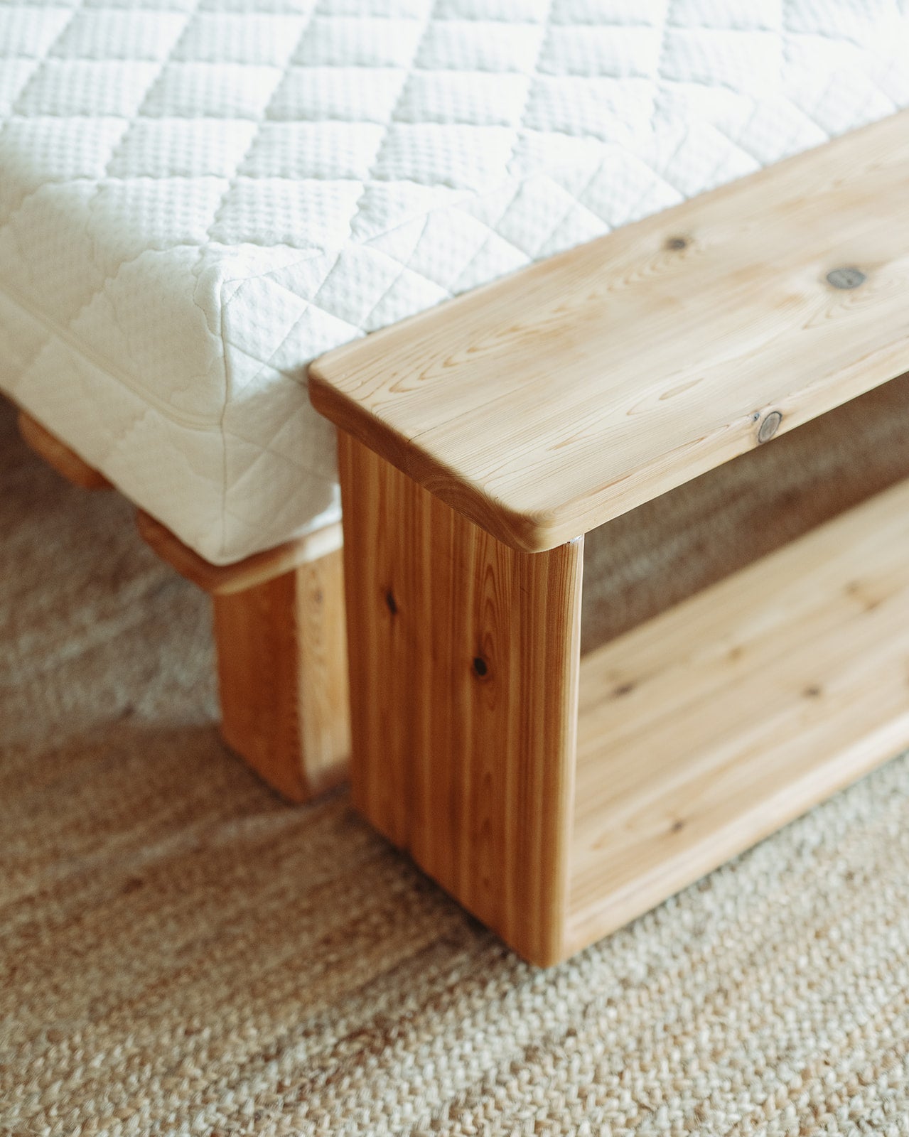 Adrift Cedar Crest Bench - corner view in front of matching bed frame with organic latex mattress