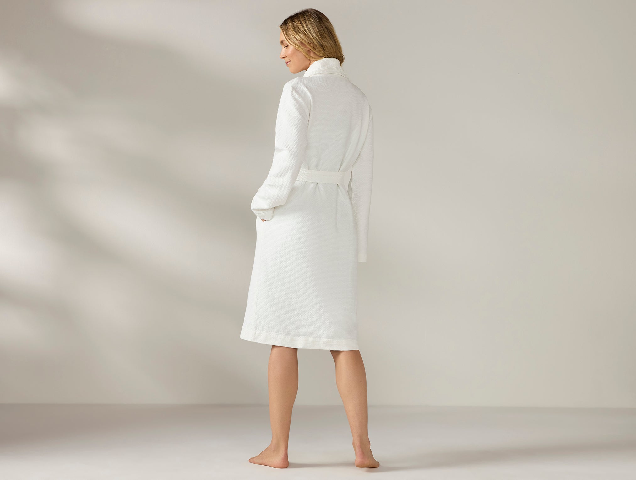 Coyuchi Organic Adriatic Robe - model posing back turned #colour_alpine white