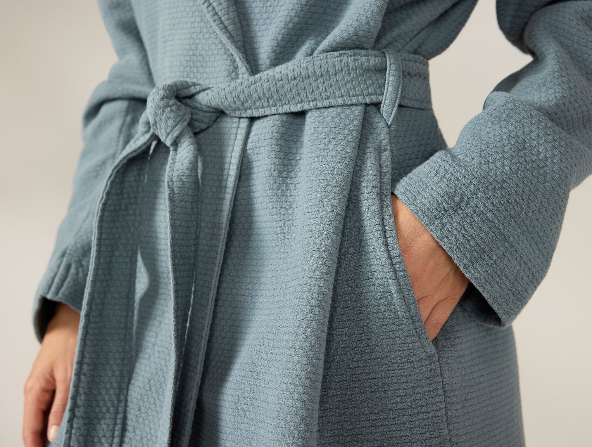 Coyuchi Adriatic Organic Robe - model hand in pocket #colour_river
