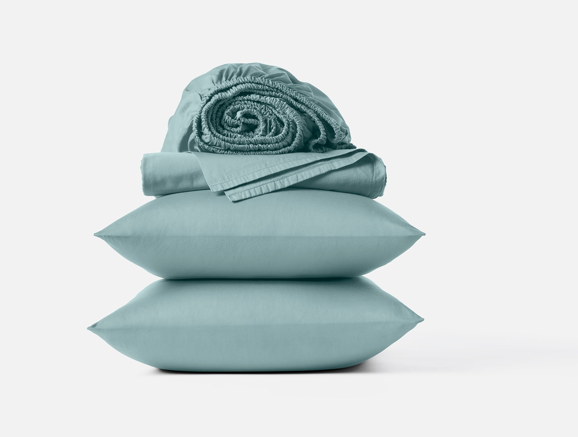 Coyuchi Cloud Soft Organic Sateen Sheet Set in Pacific Blue – stacked display with pillows and folded sheets. #colour_pacific blue