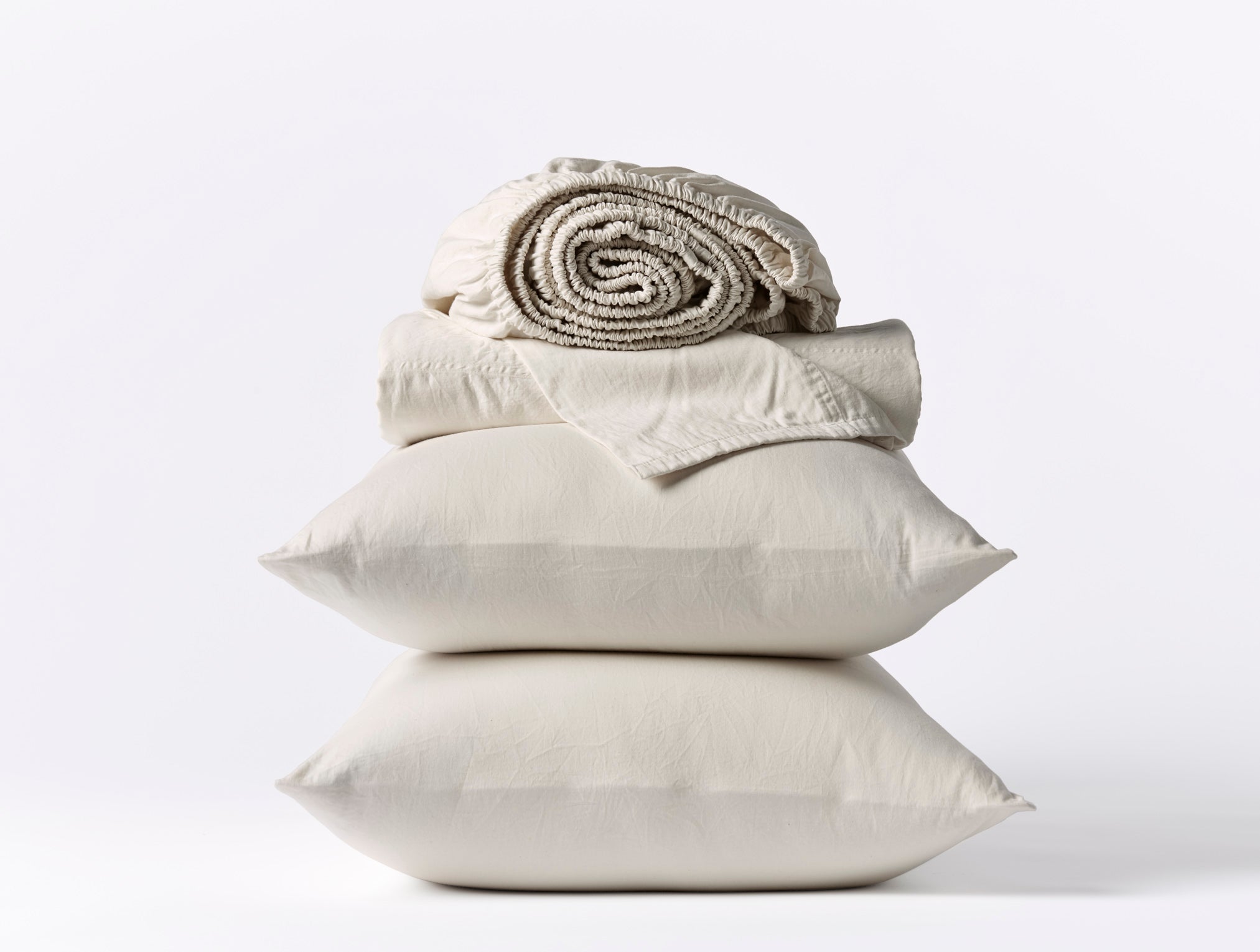 Coyuchi Cloud Soft Organic Sateen Sheet Set in Pale Grey – stacked display with pillows and folded sheets. #colour_pale grey