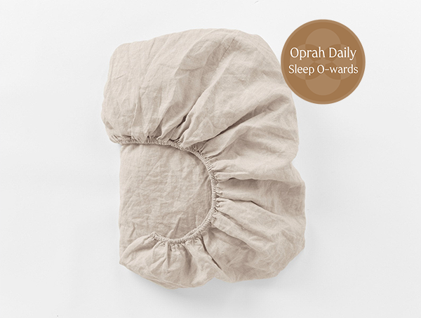 Coyuchi Organic Relaxed Linen Fitted Sheet in Natural Chambray – folded to display elastic in seam. #colour_Natural Chambrayy