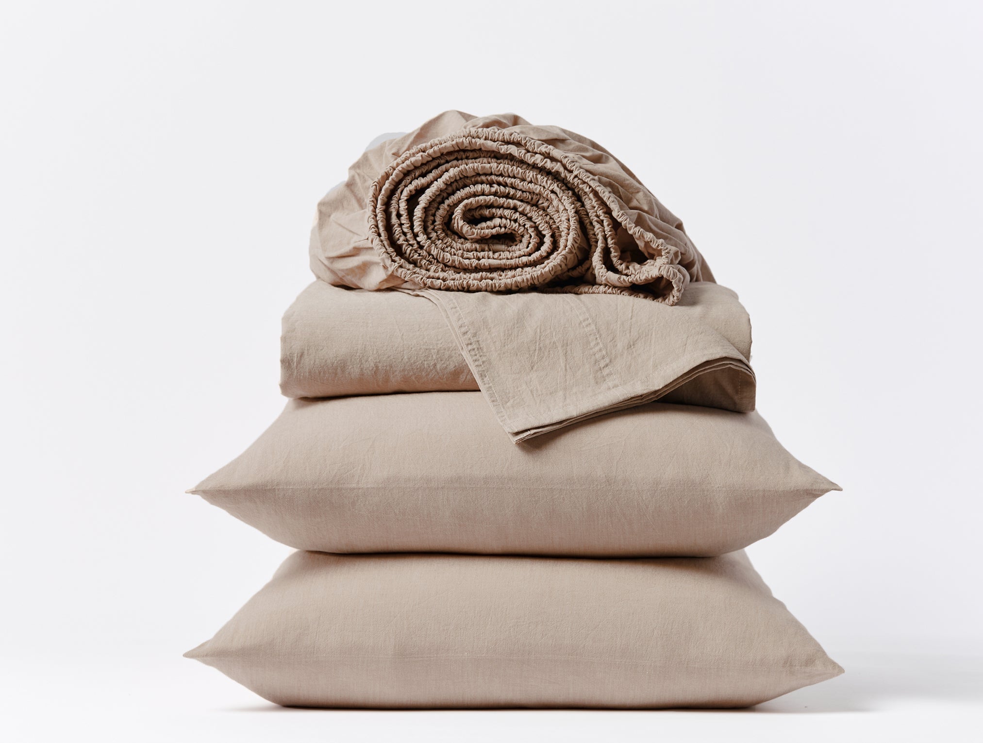 Coyuchi Organic Crinkled Percale Sheet Set in Hazel Chambray – stacked display with pillows and folded sheets. #colour_hazel chambray