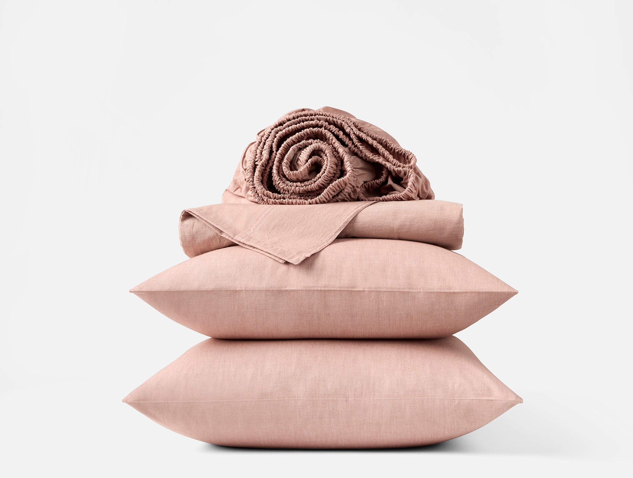 Coyuchi Organic Crinkled Percale Sheet Set in Praline Chambray – stacked display with pillows and folded sheets. #colour_praline chambray