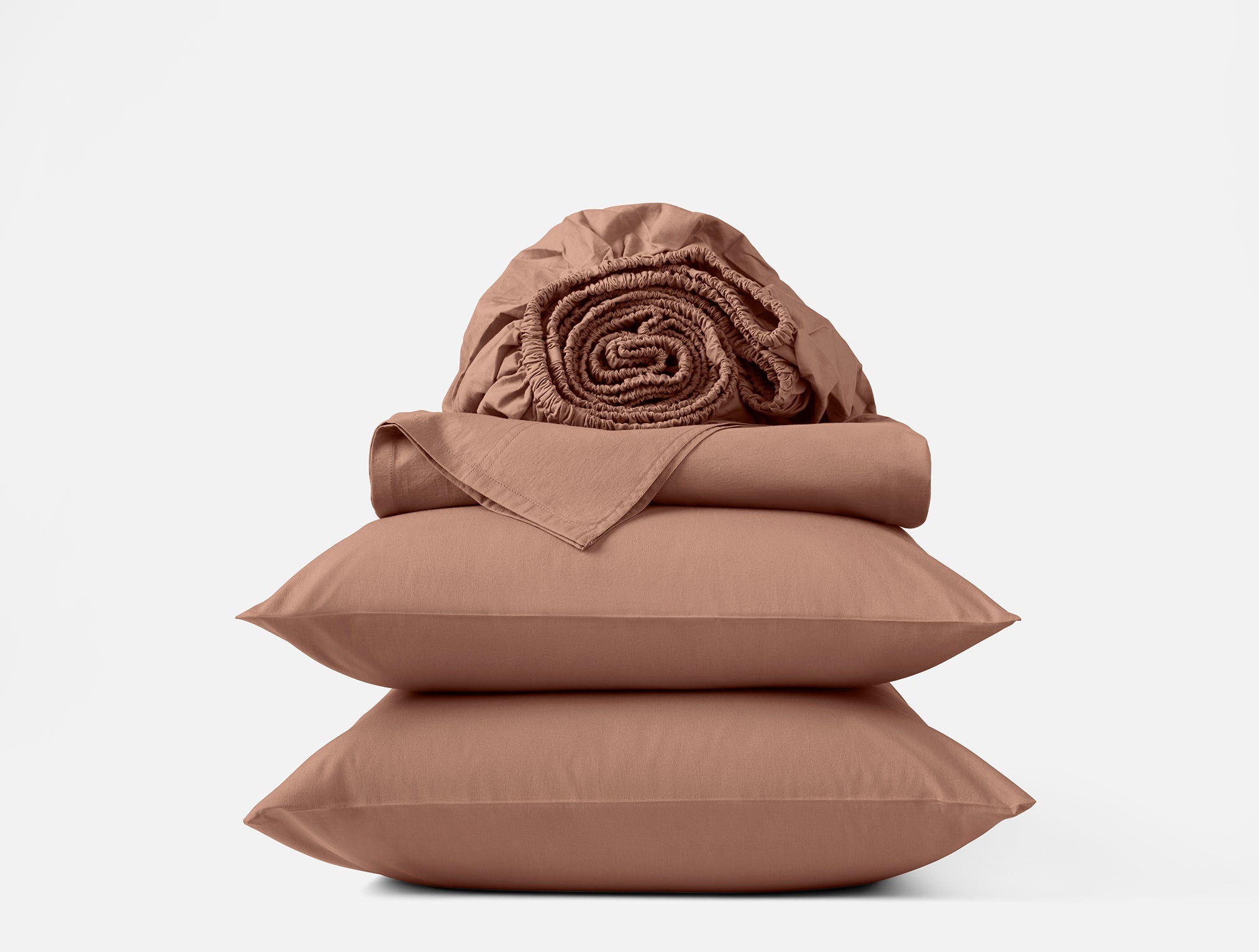 Coyuchi Organic Crinkled Percale Sheet Set in Praline – stacked display with pillows and folded sheets. #colour_praline