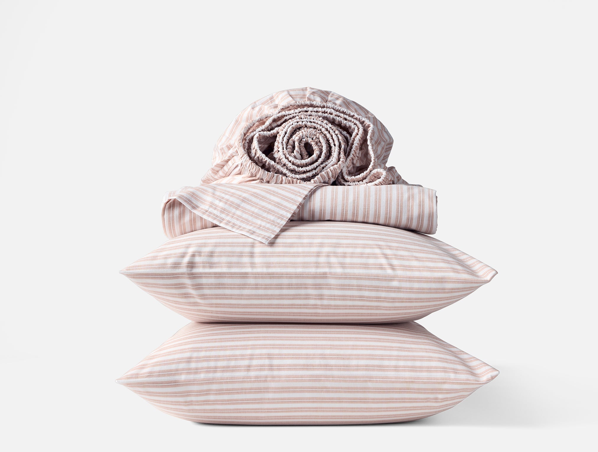 Coyuchi Organic Crinkled Percale Sheet Set in Praline Stripe – stacked display with pillows and folded sheets. #colour_praline stripe