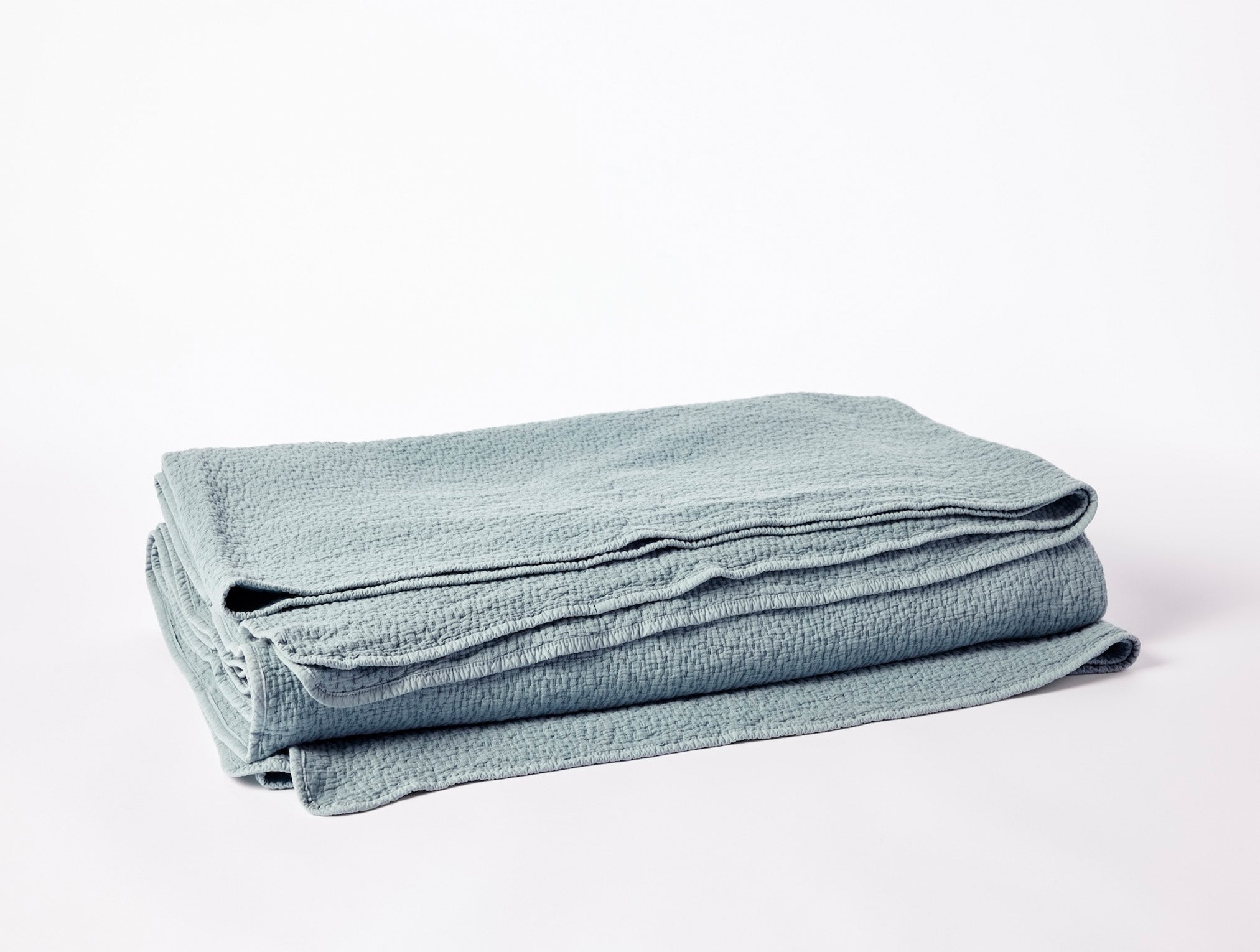 Coyuchi Organic Cascade Matelasse Blanket - folded #colour_lagoon