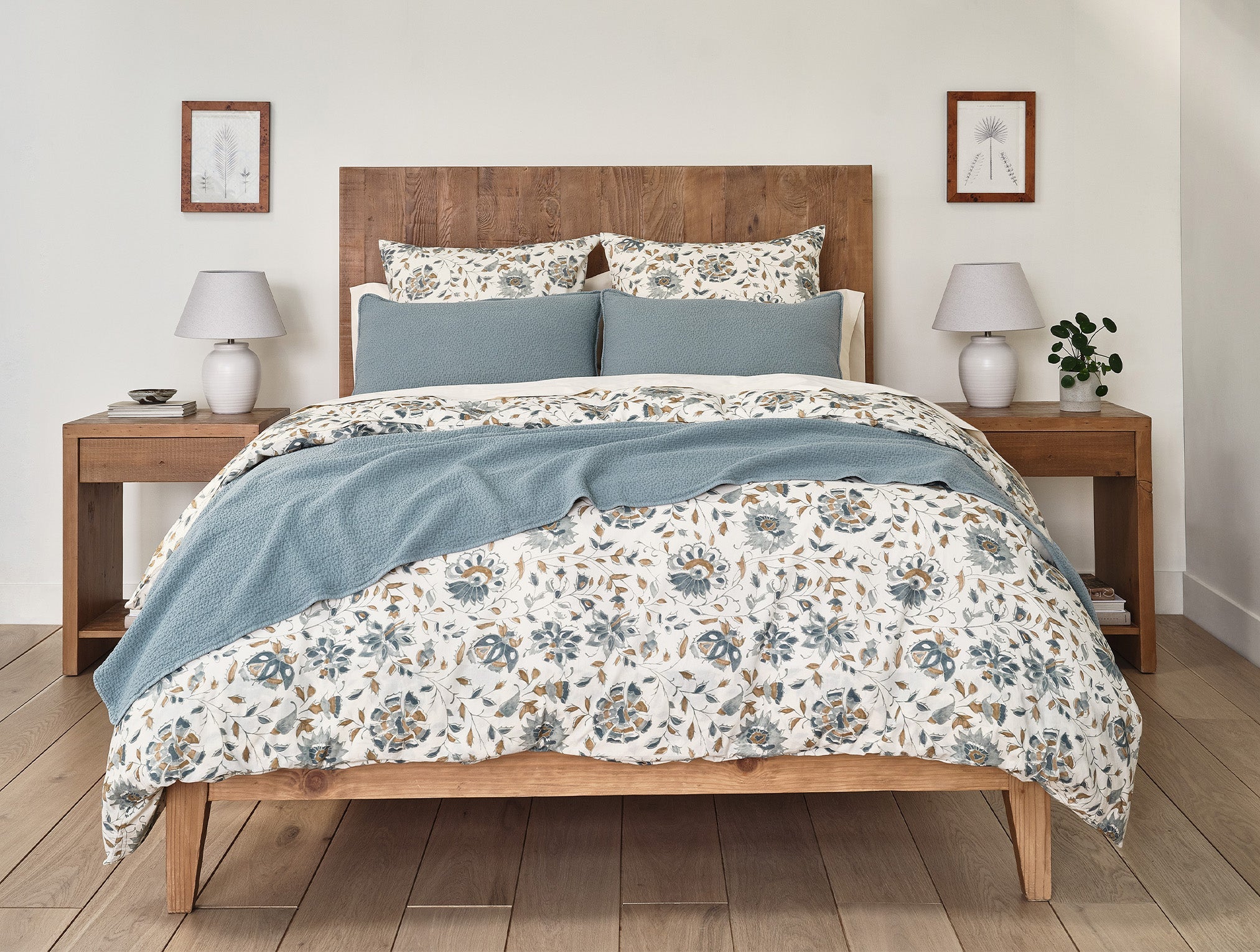 Coyuchi Organic Cascade Matelasse Blanket - draped over staged bed floral pattern #colour_lagoon