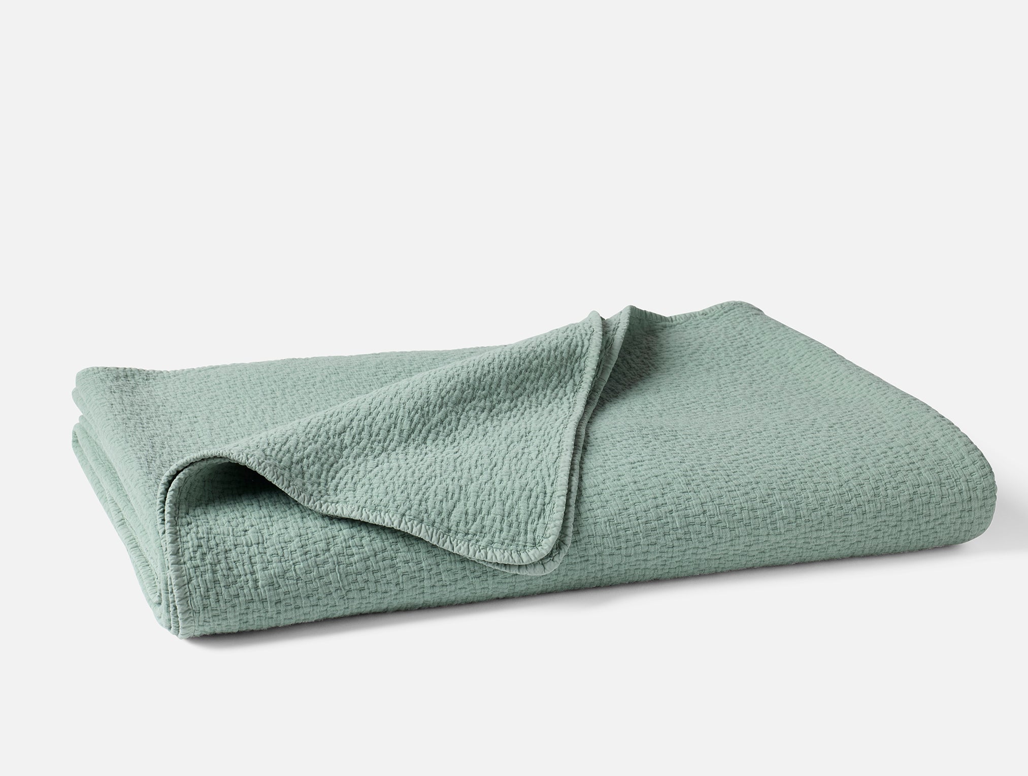 Coyuchi Organic Cascade Matelasse Blanket - folded #colour_Seafoam
