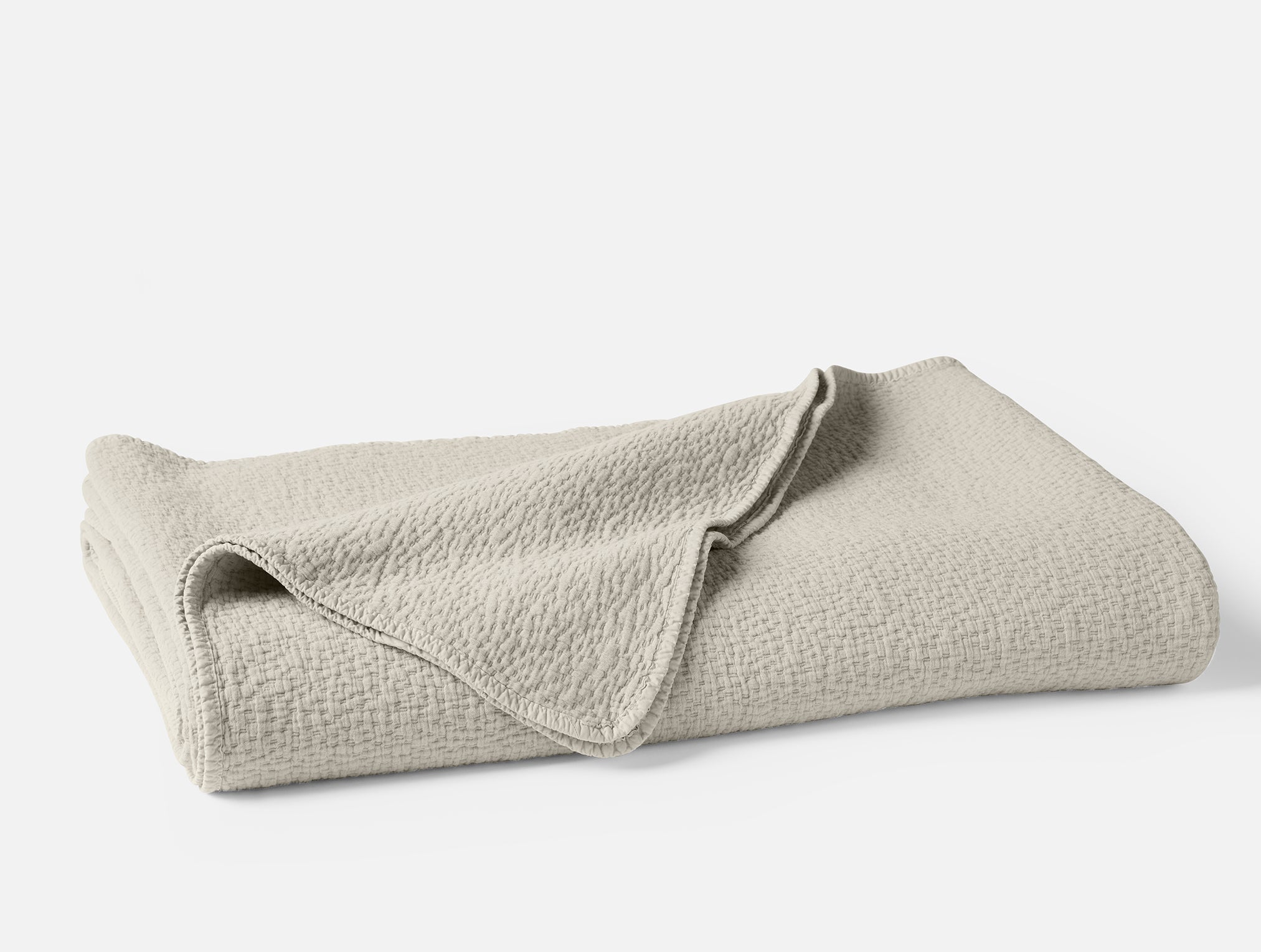 Coyuchi Organic Cascade Matelass Blanket - folded #colour_Stone