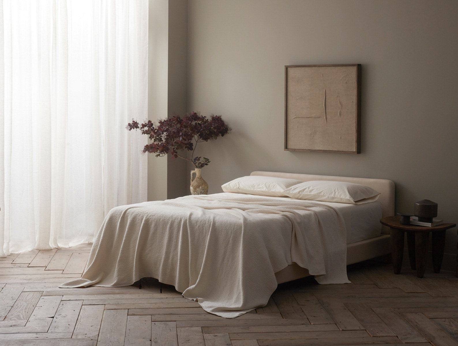 Coyuchi Organic Cascade Matelasse Blanket - staged bed natural lighting #colour_Undyed