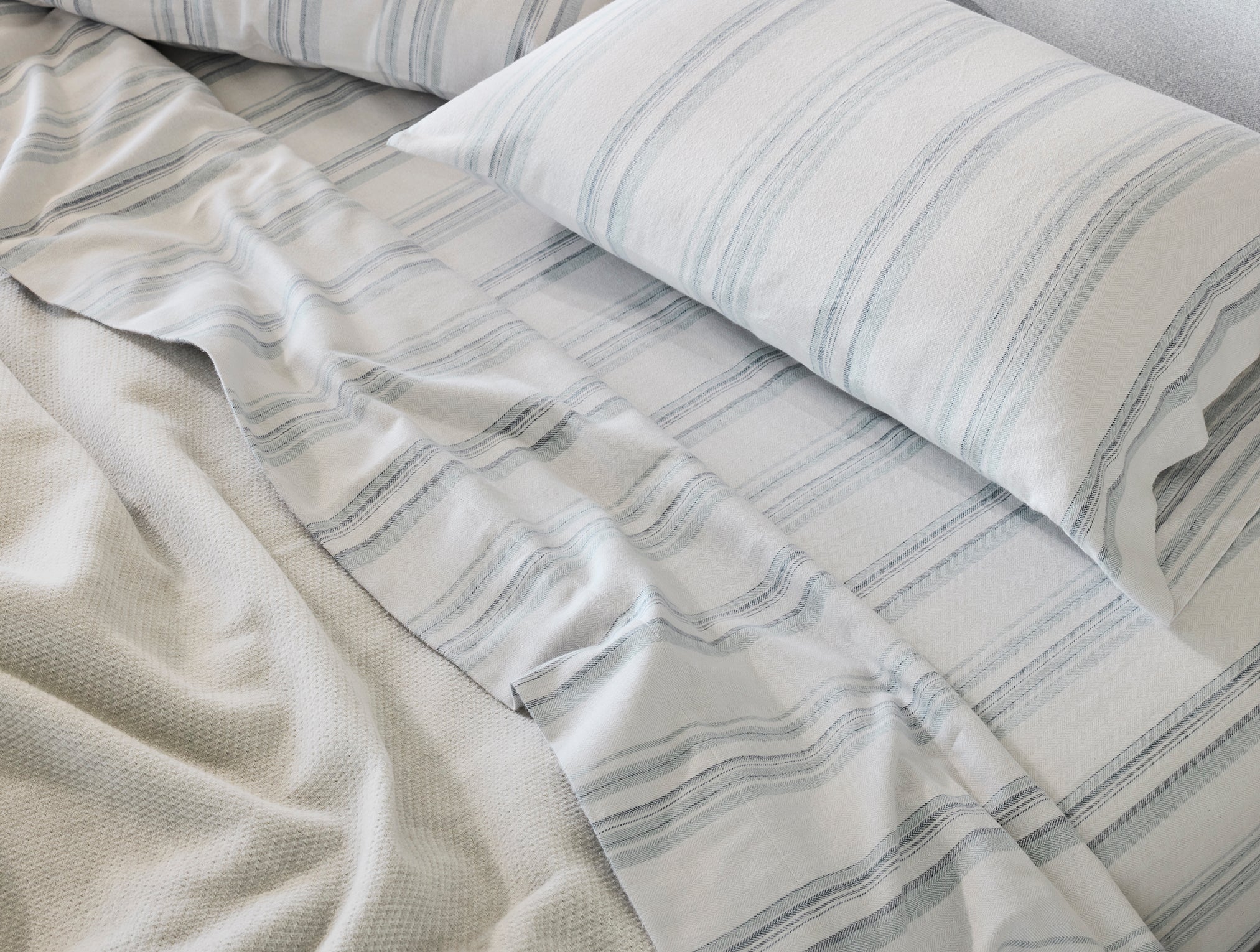 Coyuchi Organic Cloud Brushed Flannel Pillowcase - matching sheets staged bed close up #colour_gulf herringbone stripe