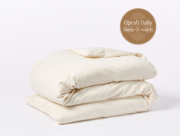 Coyuchi Organic Cloud Soft Sateen Duvet Cover - folded with Oprah Daily Sleep O-ward #colour_none