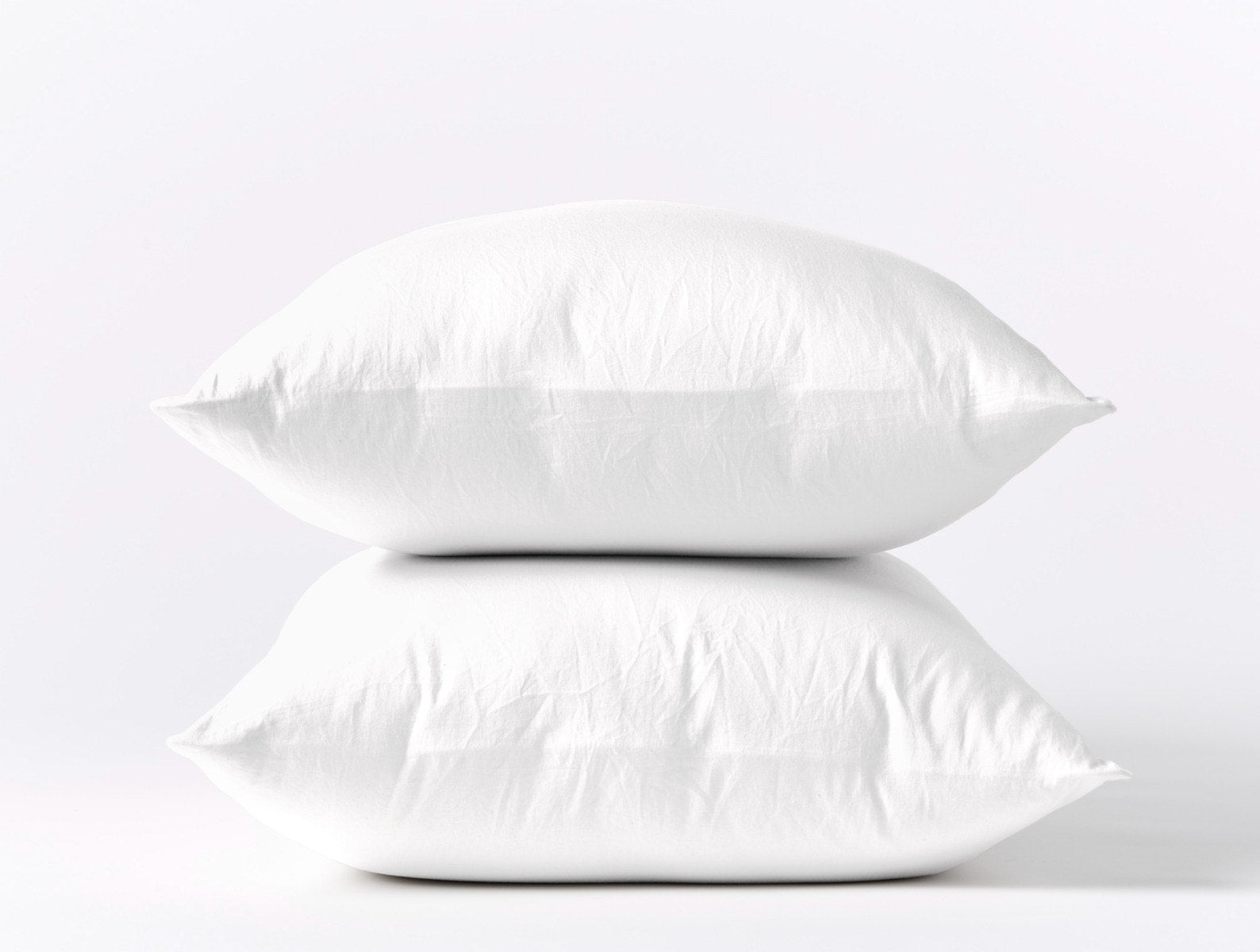 Coyuchi Organic Cloud Soft Sateen Pillowcases - stacked pillows #colour_alpine white