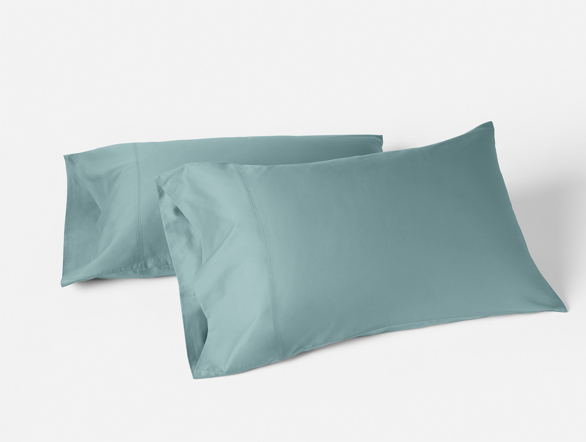 Coyuchi Organic Cloud Soft Sateen Pillowcase - stacked in front of each other #colour_pacific blue