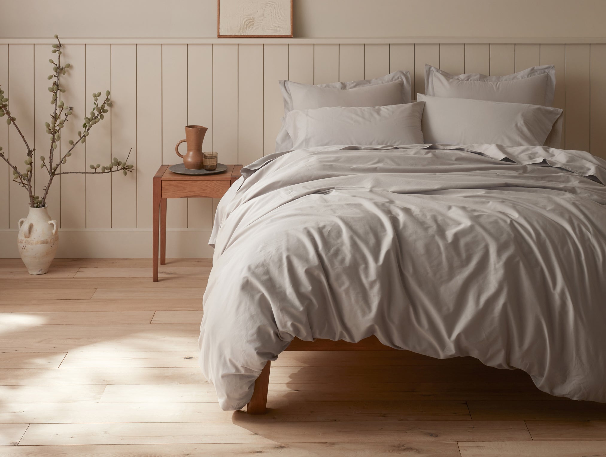 Coyuchi Organic Cloud Soft Sateen Pillows - staged bed soft lighting from window #colour_pale gray