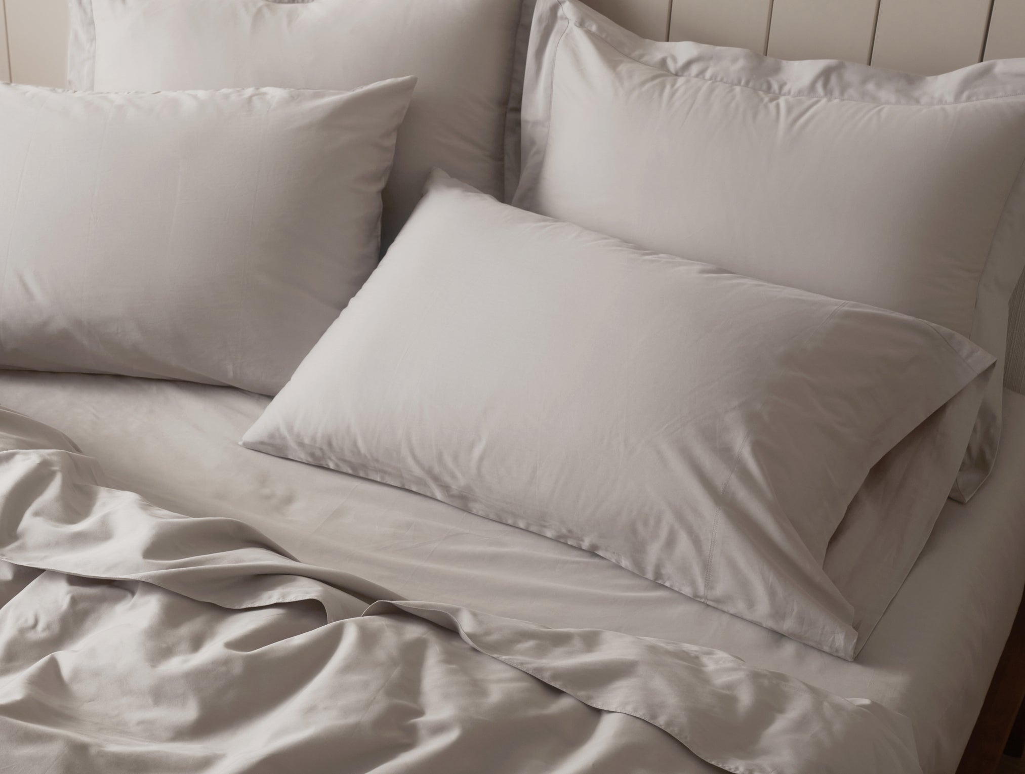 Coyuchi Organic Cloud Soft Sateen Pillowcase - staged bed view of pillows #colour_pale gray