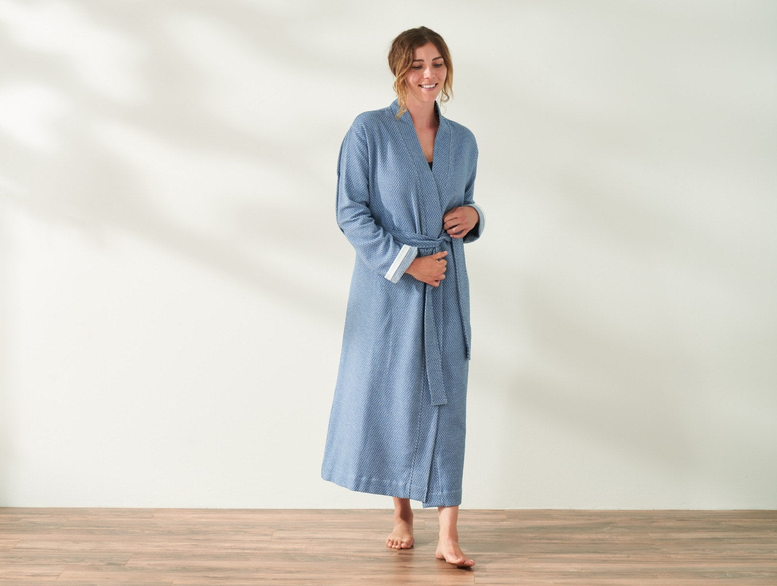 Coyuchi Organic Cotton Mediterranean Modern Robe - model taking step while wearing robe #colour_lake