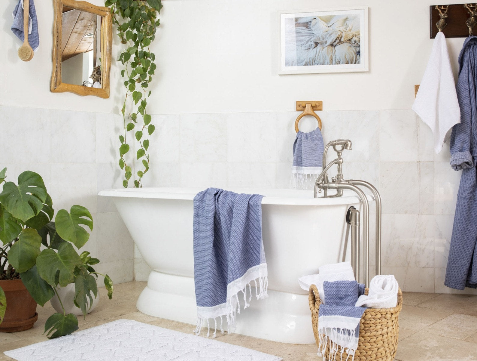 Coyuchi Organic Cotton Mediterranean Towel - draped over tub in staged bathroom with plants #colour_Lake w/ Sea Spray Stripes