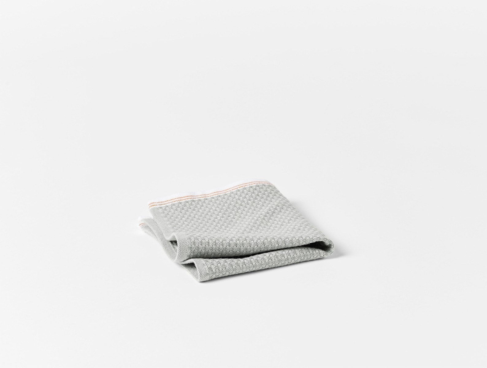 Coyuchi Organic Cotton Mediterranean Wash Cloth - folded #colour_Deep Pewter w/ Tangerine Stripes