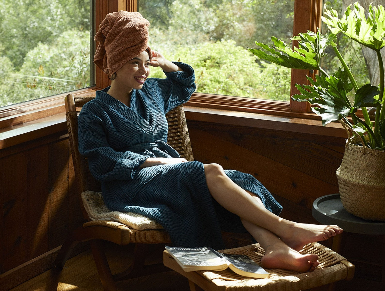 Coyuchi Organic Cotton Unisex Waffle Robe - model wearing with large window and natural lighting #colour_deep ocean