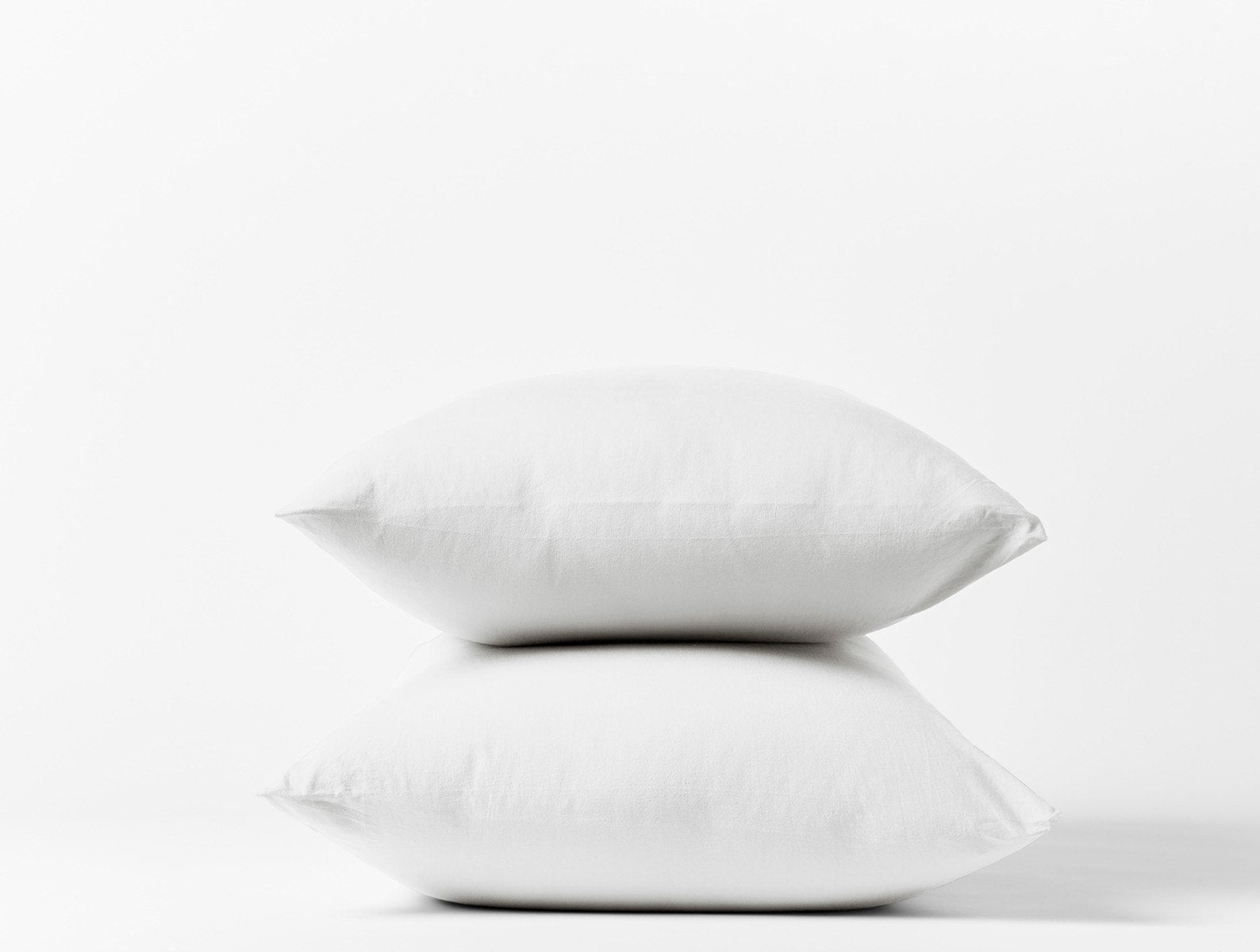 Coyuchi Crinkled Percale Pillowcase - stacked with white background #colour_alpine white
