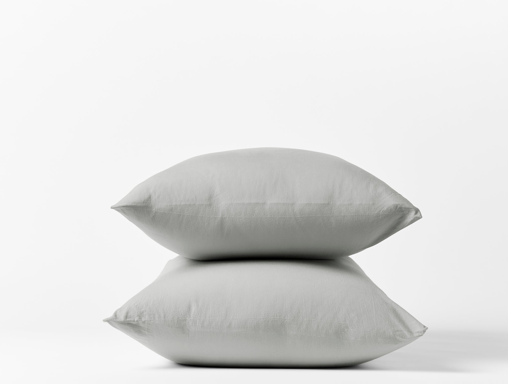 Coyuchi Crinkled Percale Pillowcase - stacked with white background #colour_pewter