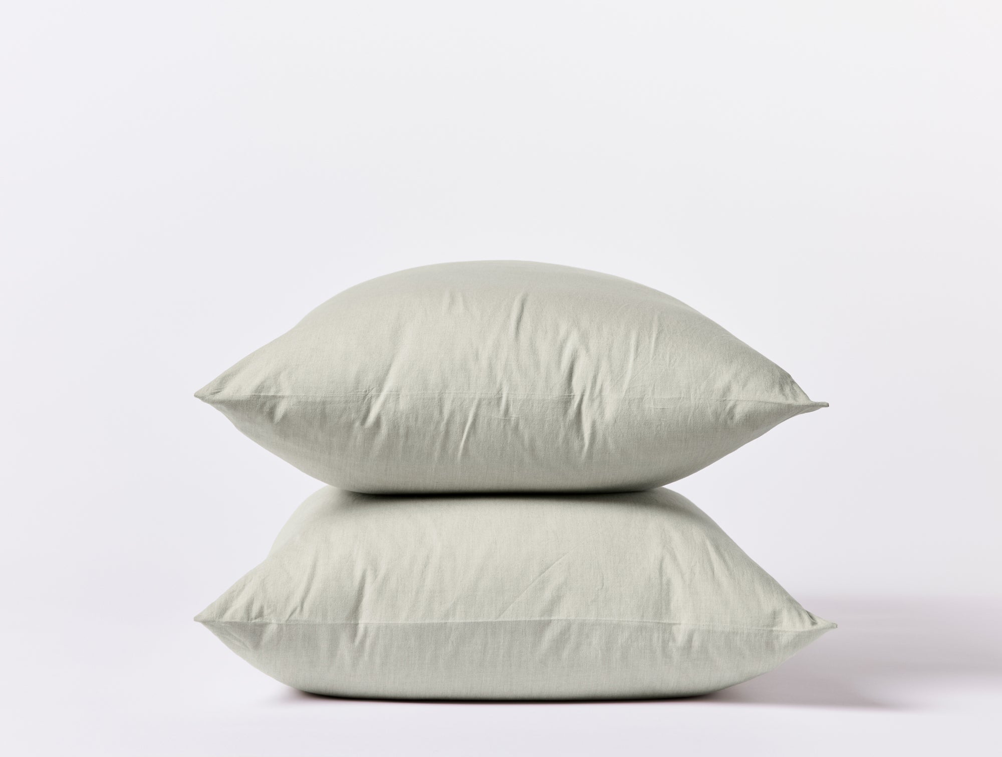 Coyuchi Crinkled Percale Pillowcases - stacked with white background #colour_laurel chambray