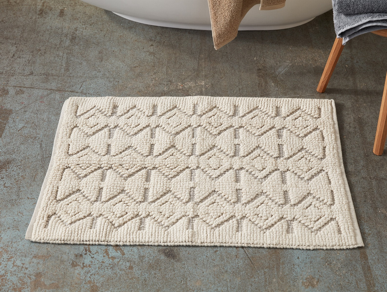 Coyuchi Organic Mosaic Canyon Bath Rug - on floor in front of bath tub #colour_Undyed w/ Slate
