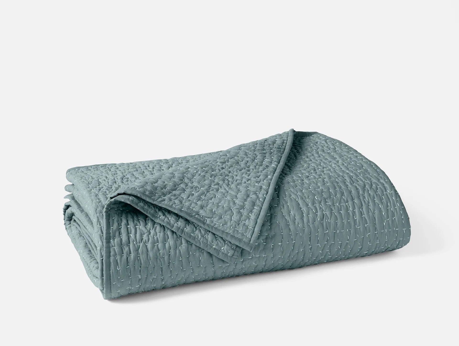 Coyuchi Organic Pebbled Hand Stitched Quilt - folded #colour_lagoon