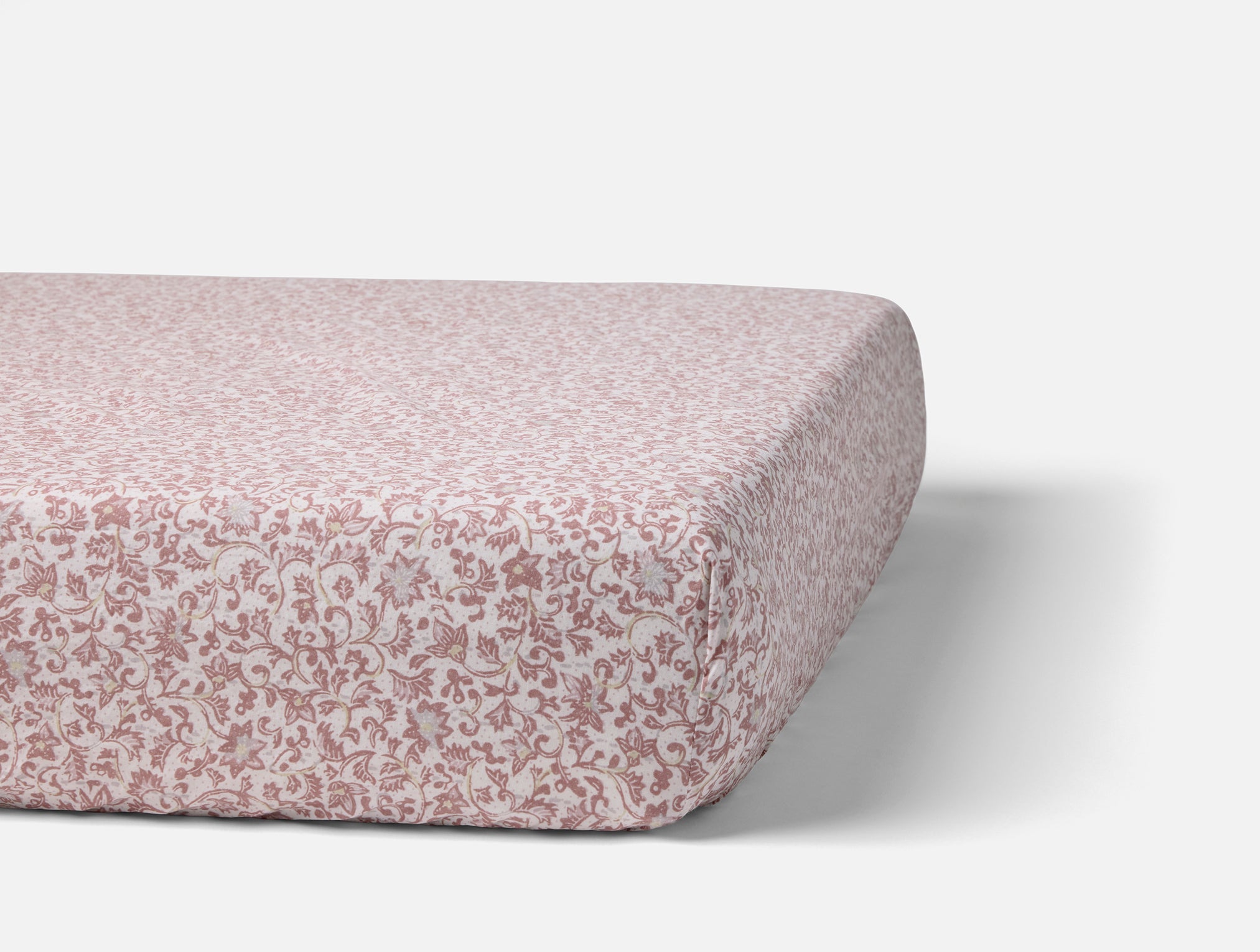 Coyuchi Organic Cotton Crinkled Percale Crib Sheet in Plum Blossom Asterid - on crib mattress #colour_plum blossom asterid