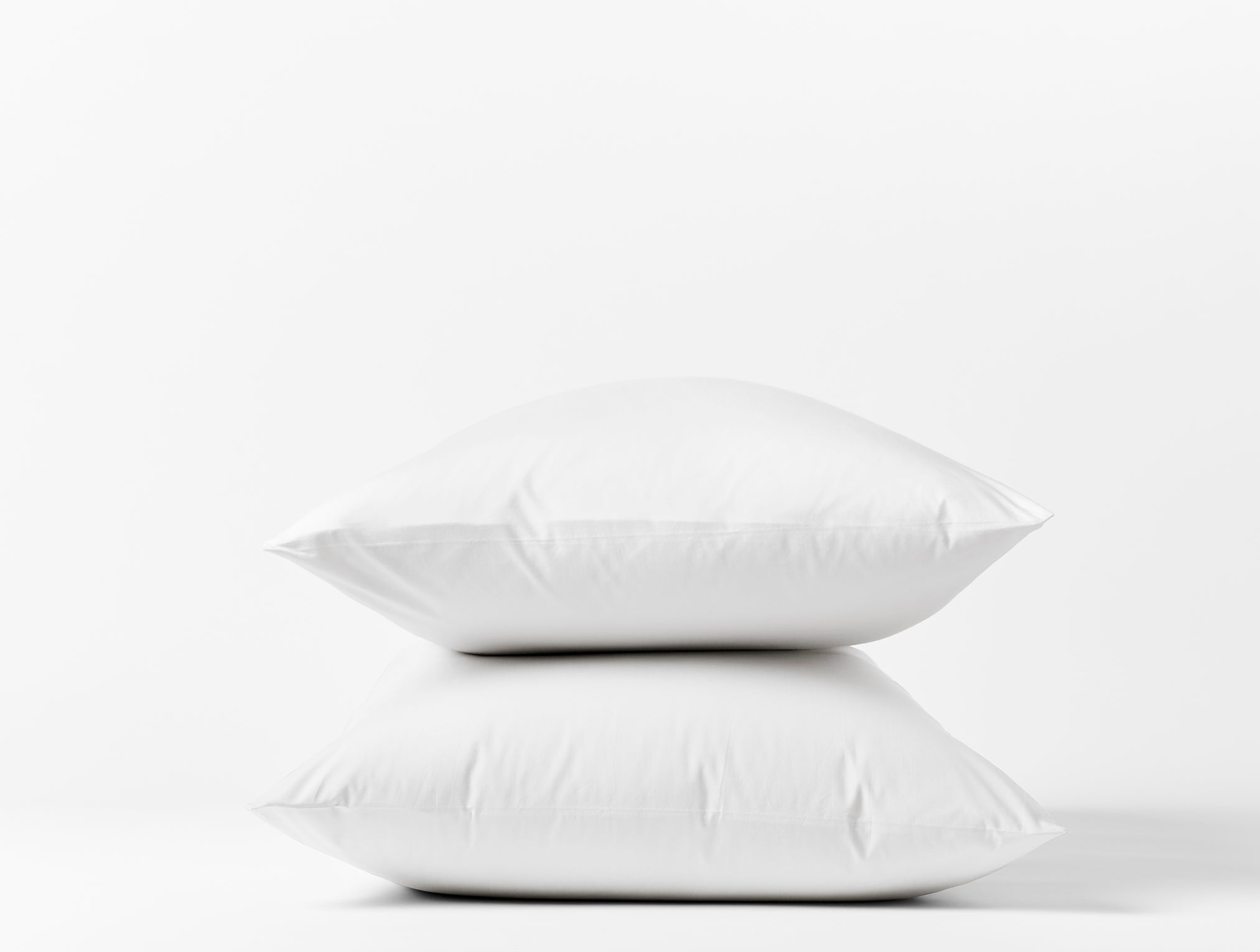 Coyuchi Organic Refined Percale Pillowcase - stacked with white background #colour_alpine white