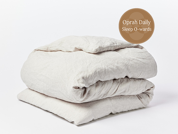 Coyuchi Organic Relaxed Linen Duvet Cover - folded with Oprah Daily award badge #colour_natural chambrayy