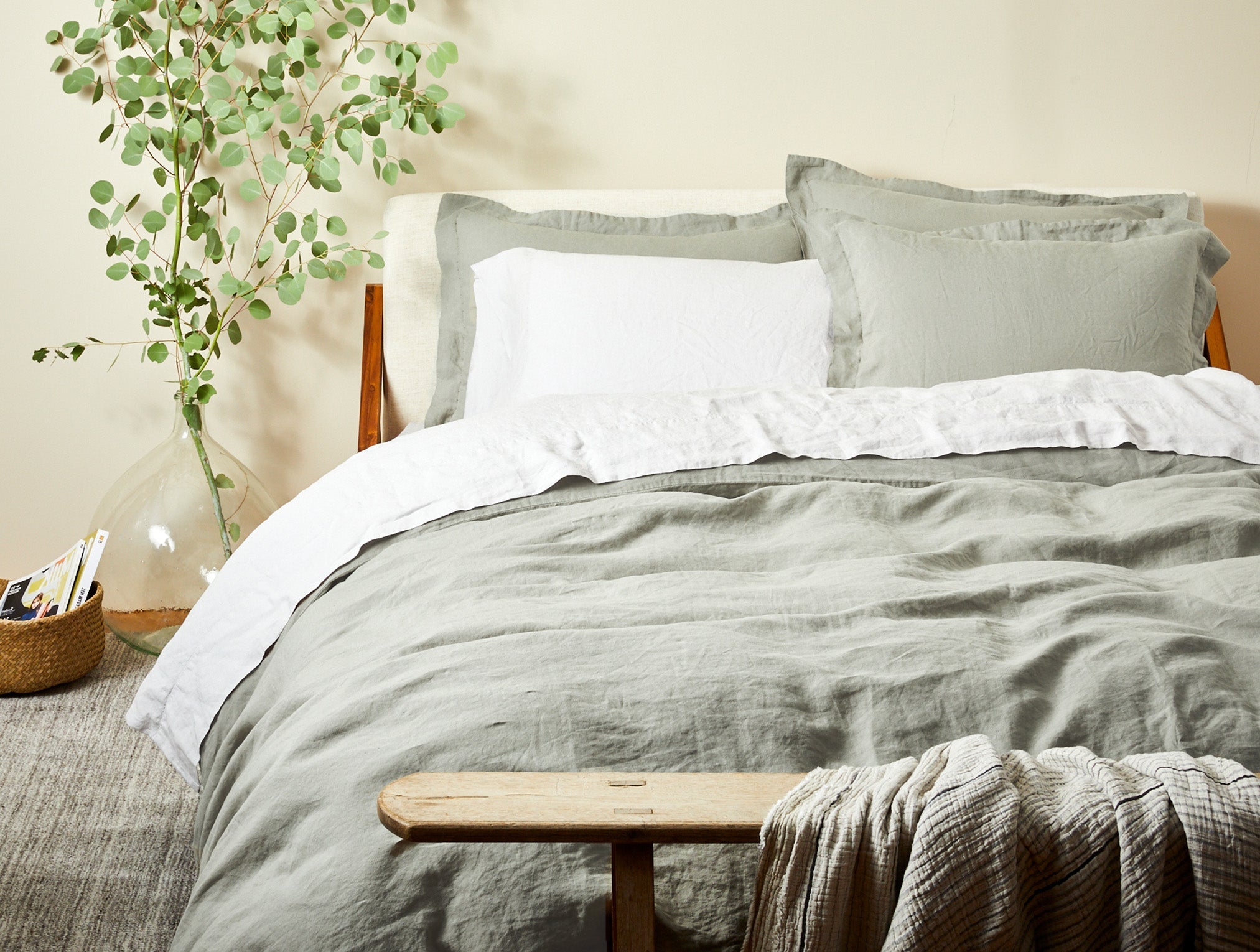 Coyuchi Organic Relaxed Linen Duvet Cover - staged bed with plant #colour_laurel
