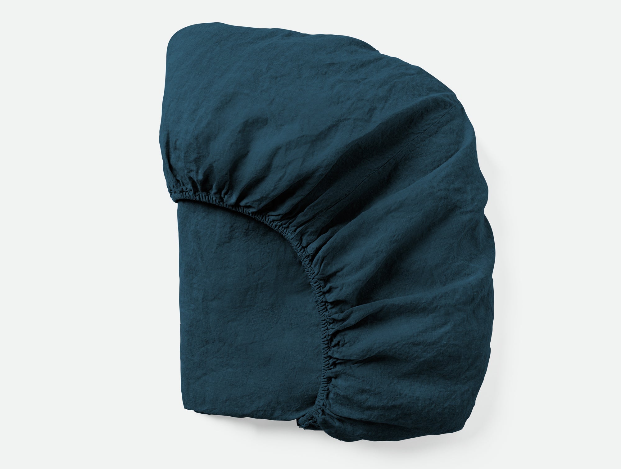 Coyuchi Organic Relaxed Linen Fitted Sheet in Midnight Indigo - folded showing elastic #colour_midnight indigo