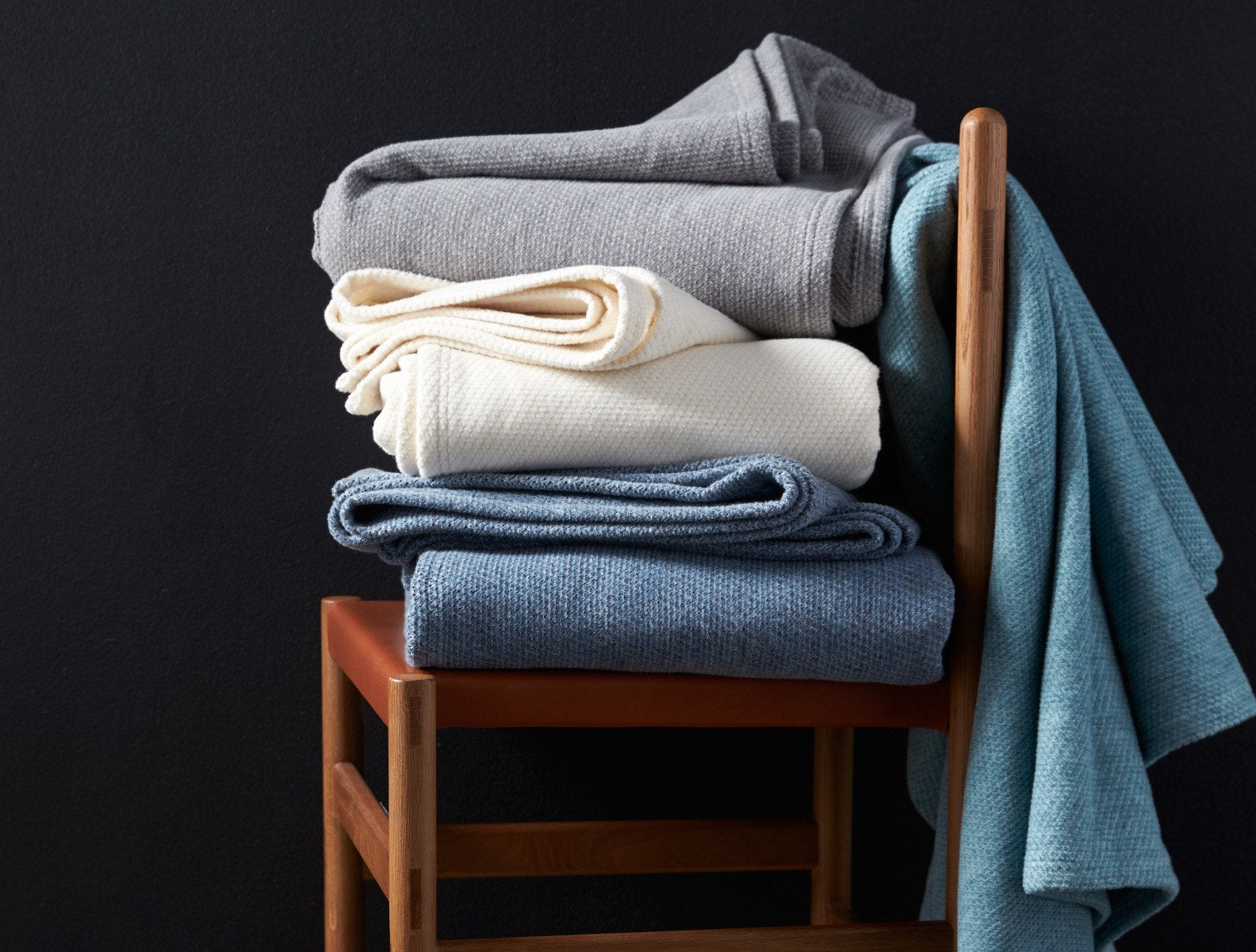 Coyuchi Organic Sequoia Cotton Wool Blanket - undyed gray blue stacked on chair #colour_blue