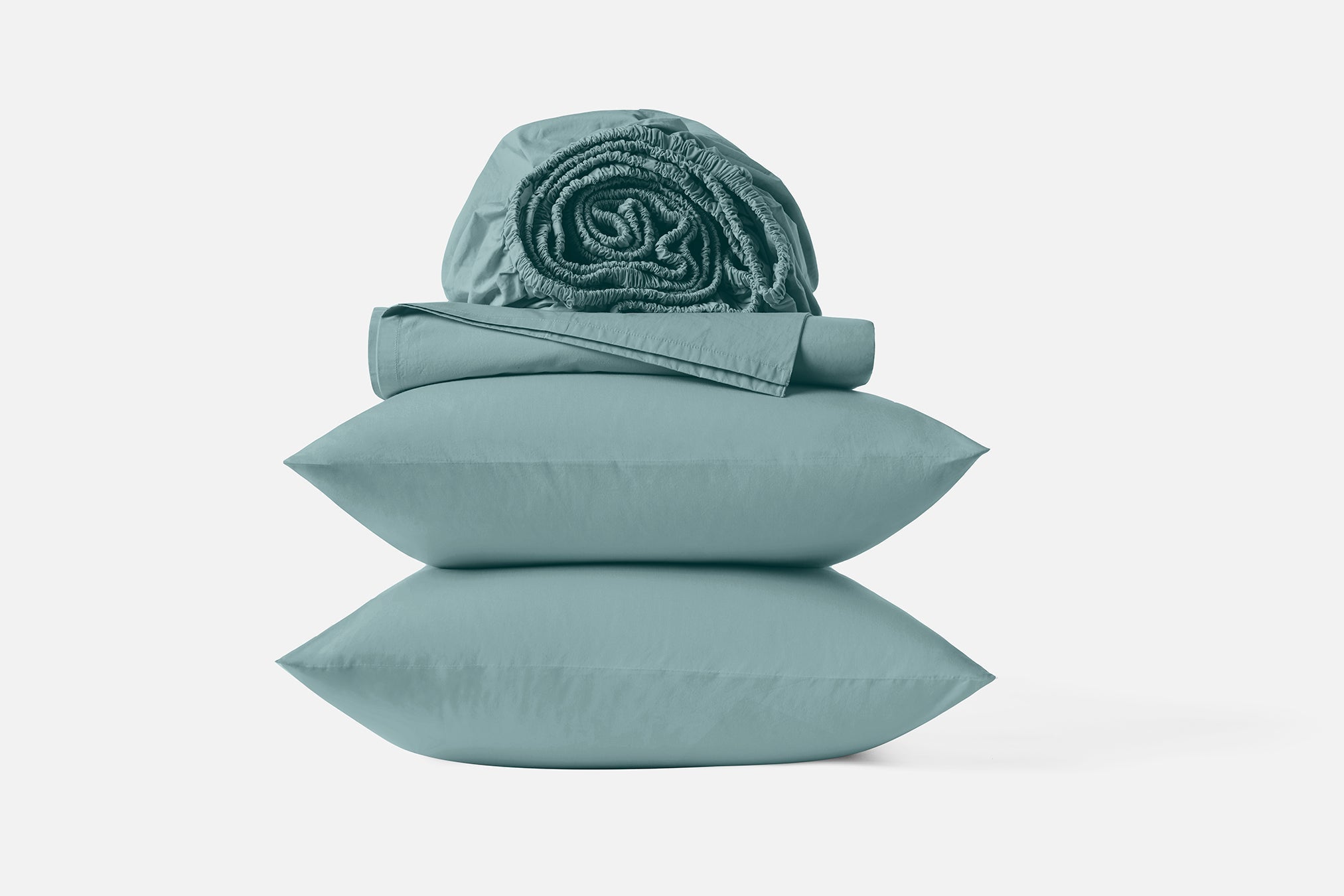 Coyuchi Refined Organic Cotton Percale Sheet Set in Pacific Blue – stacked display with pillows and folded sheets. #colour_pacific blue
