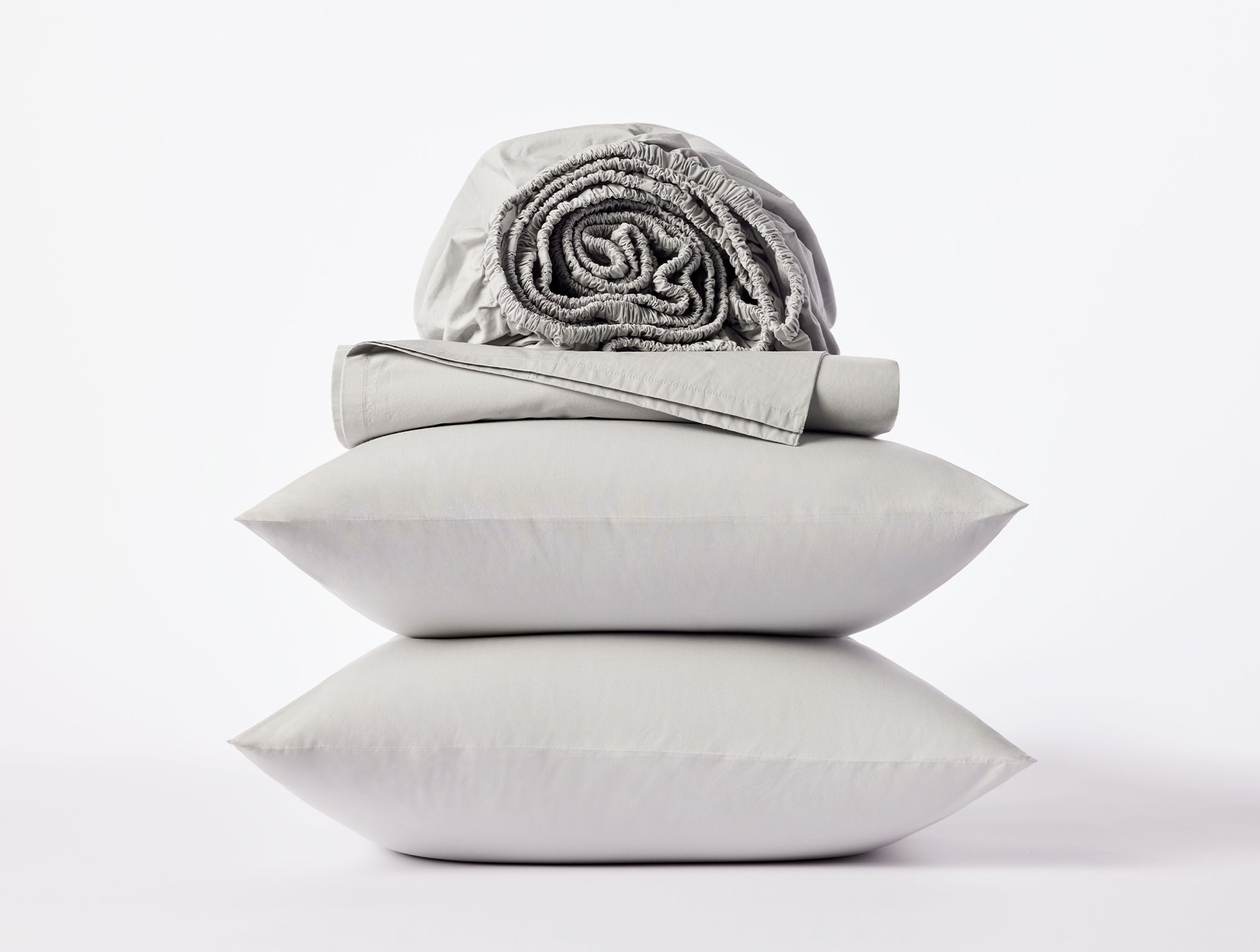 Coyuchi Refined Organic Cotton Percale Sheet Set in Seal – stacked display with pillows and folded sheets. #colour_seal