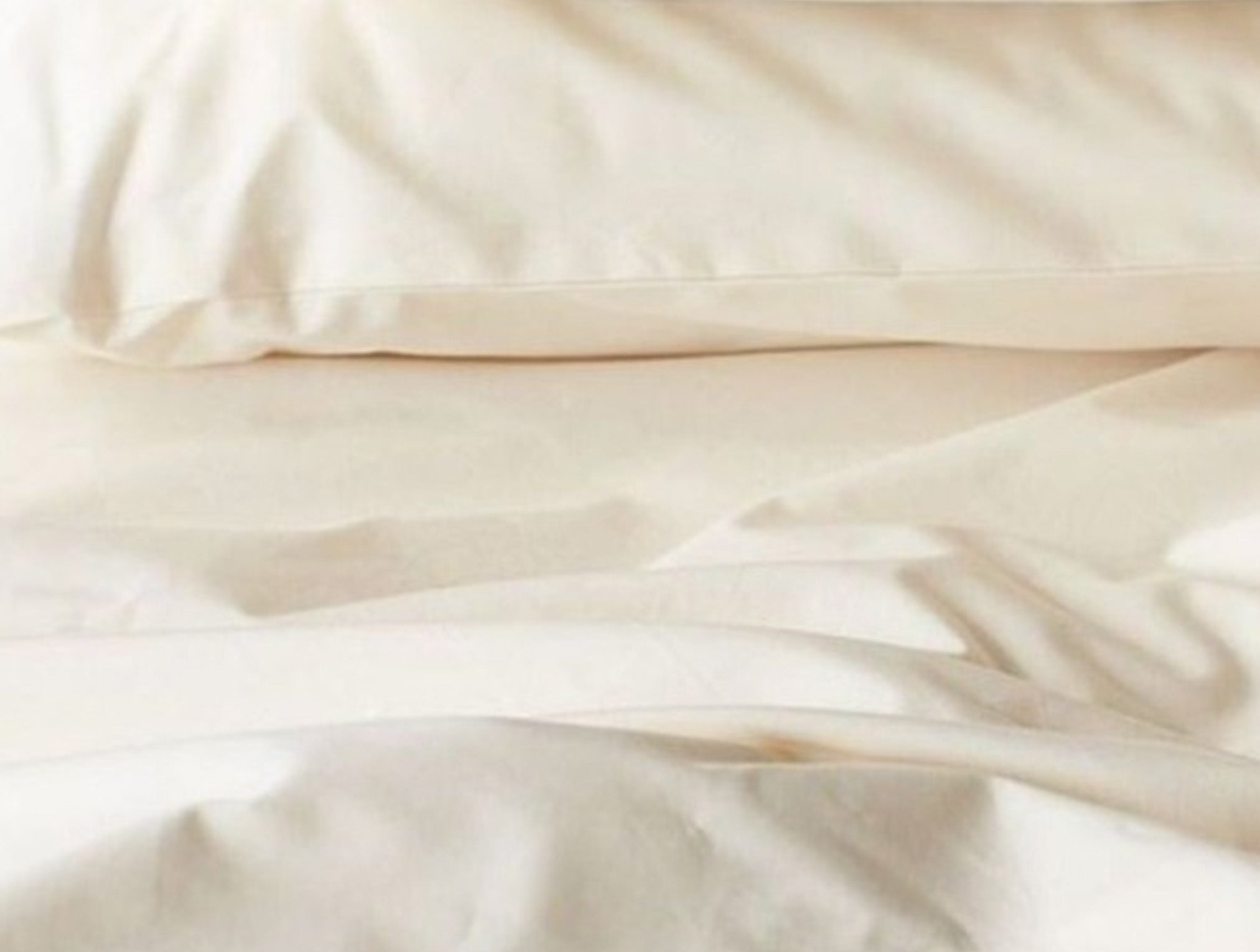 Coyuchi Refined Organic Cotton Percale Sheet Set in Undyed - close-up view showing texture and weave quality. #colour_undyed