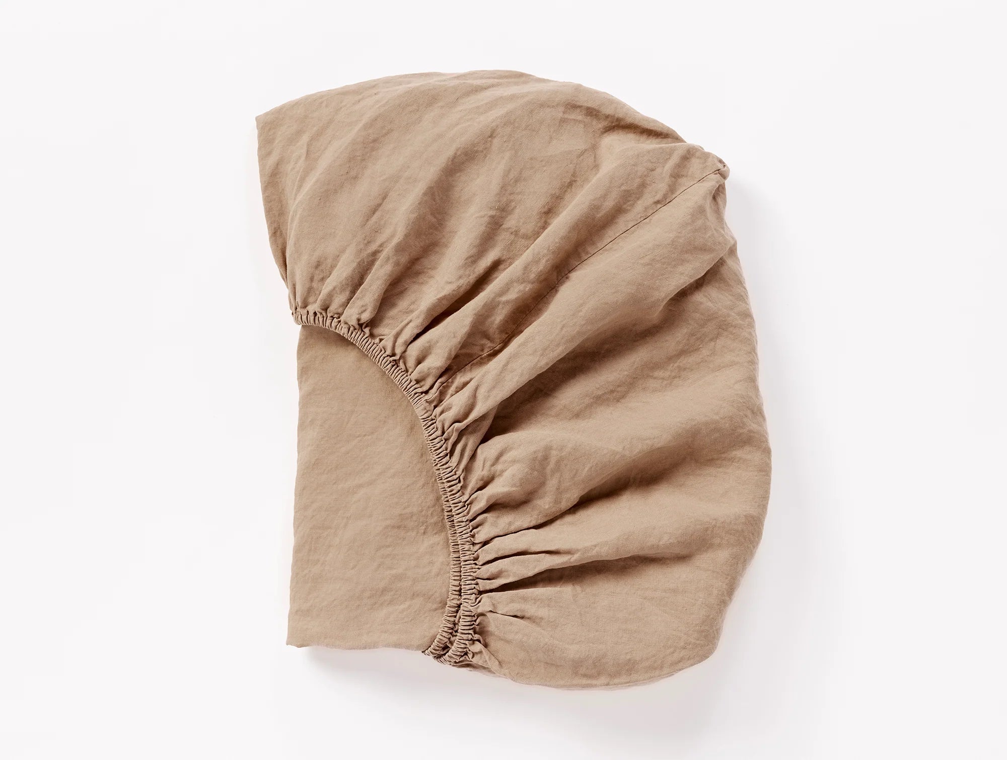 Coyuchi Organic Relaxed Linen Fitted Sheet in Doe – folded to display elastic in seam. #colour_Doe