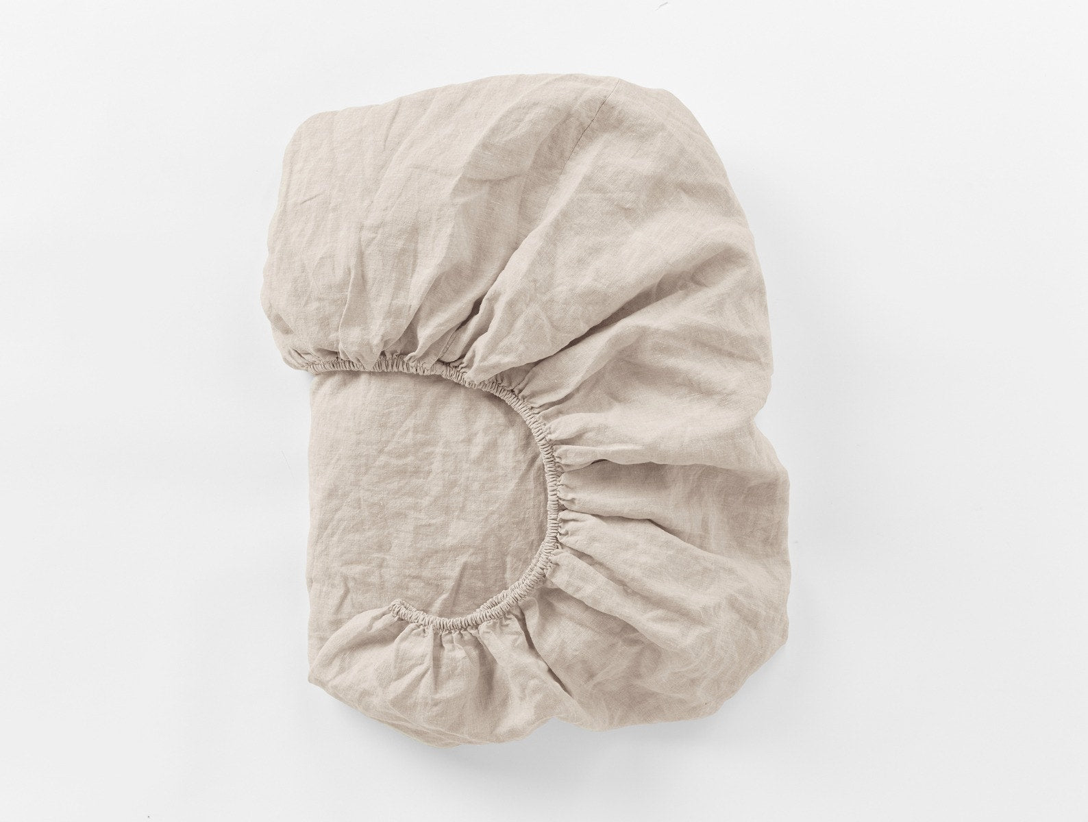 Coyuchi Organic Relaxed Linen Fitted Sheet in Natural Chambray – folded to display elastic in seam. #colour_Natural Chambray