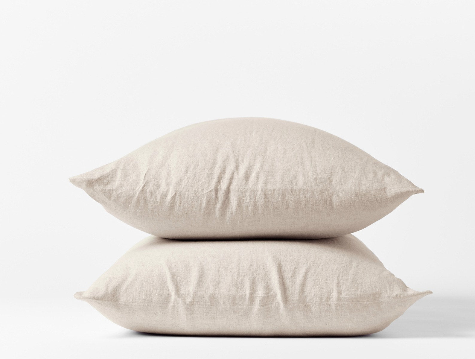 Coyuchi Organic Relaxed Linen Pillowcases in Natural Chambray – two stacked pillows, showing pillowcase fit and linen texture. #colour_natural chambray