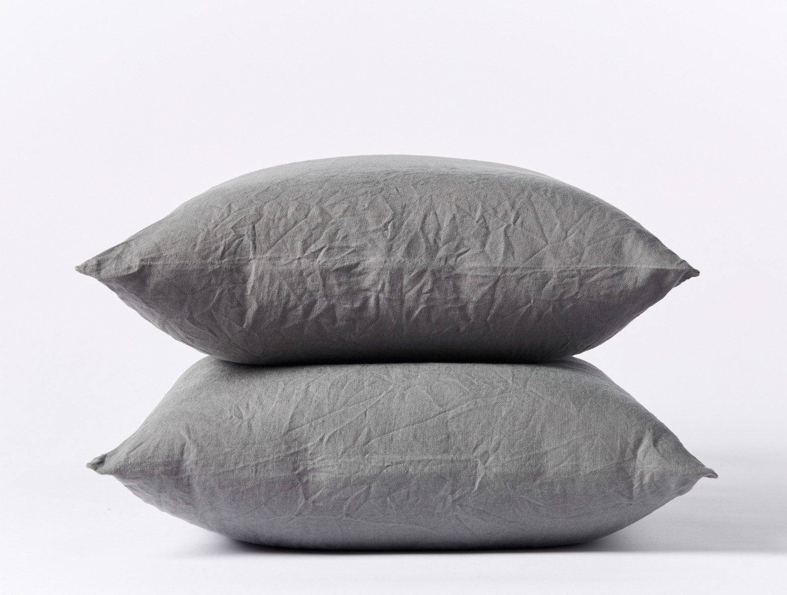 Coyuchi Organic Relaxed Linen Pillowcases in Slate – two stacked pillows, showing pillowcase fit and linen texture. #colour_slate