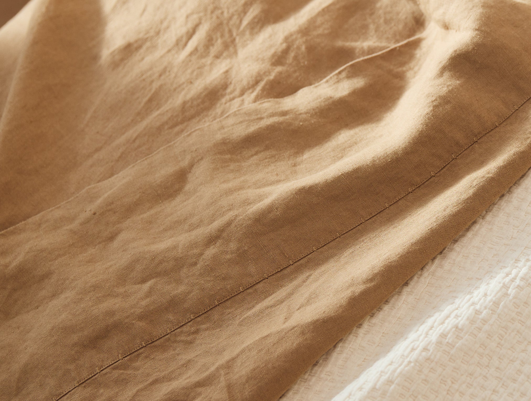 Coyuchi Organic Relaxed Linen Sheet Set in Doe – close-up view, showing texture, weave and stitching quality. #colour_doe