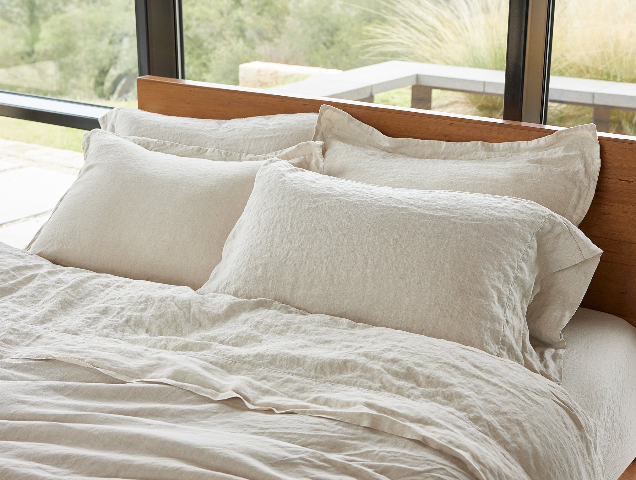 Coyuchi Organic Relaxed Linen Sheet Set in Natural Chambray – detail shot on made bed. #colour_natural chambray