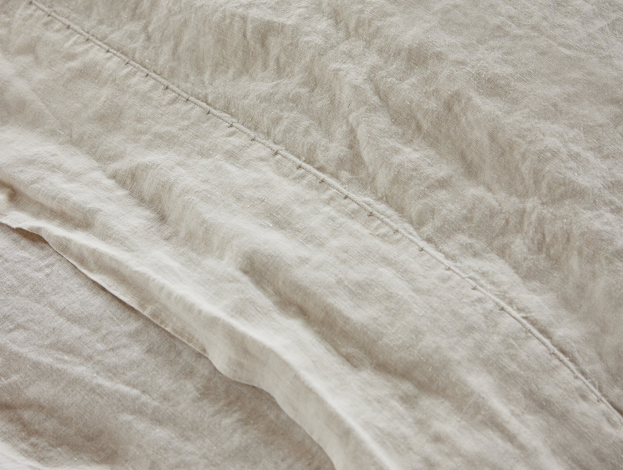 Coyuchi Organic Relaxed Linen Sheet Set in Natural Chambray – close-up of linen texture and weave. #colour_natural chambray